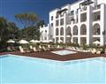 Enjoy a glass of wine at Ocean Suite I; Pine Cliffs Resort; Portugal