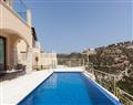 Enjoy a glass of wine at Elite Junior Villa Turquoise; Aphrodite Hills Resort; Paphos