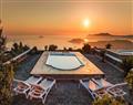 Enjoy a glass of wine at Villa Caldera Sunset; Megalohori; Santorini